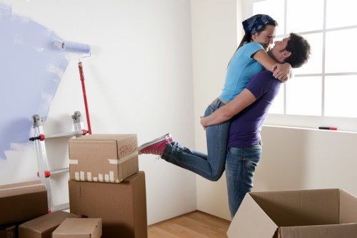 Removal van and movers working near a Canary Wharf apartment complex
