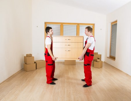 Removal team handling office furniture near Canary Wharf towers